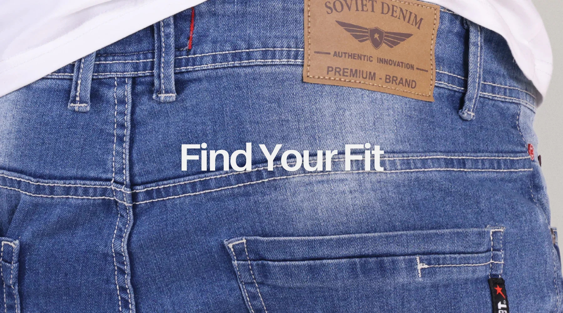 Close-up of blue denim jeans back with leather patch and 'Find Your Fit' text overlay
