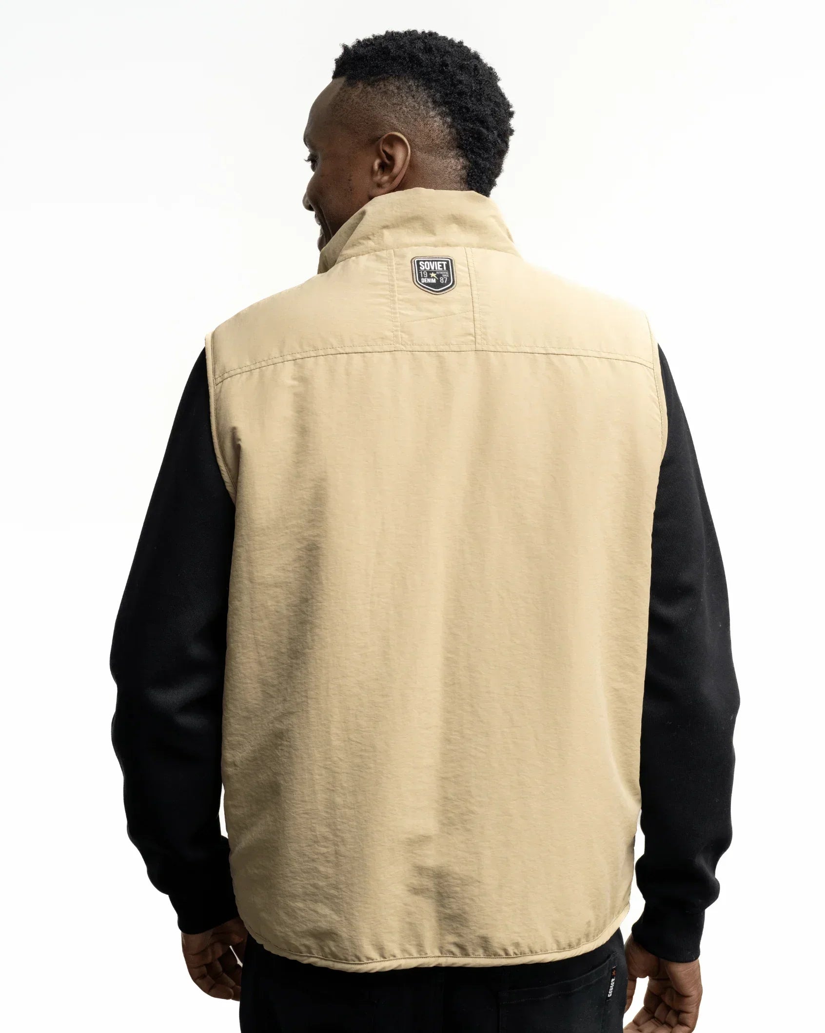Men's stone fashion gilet back with neck label and flap pocket details