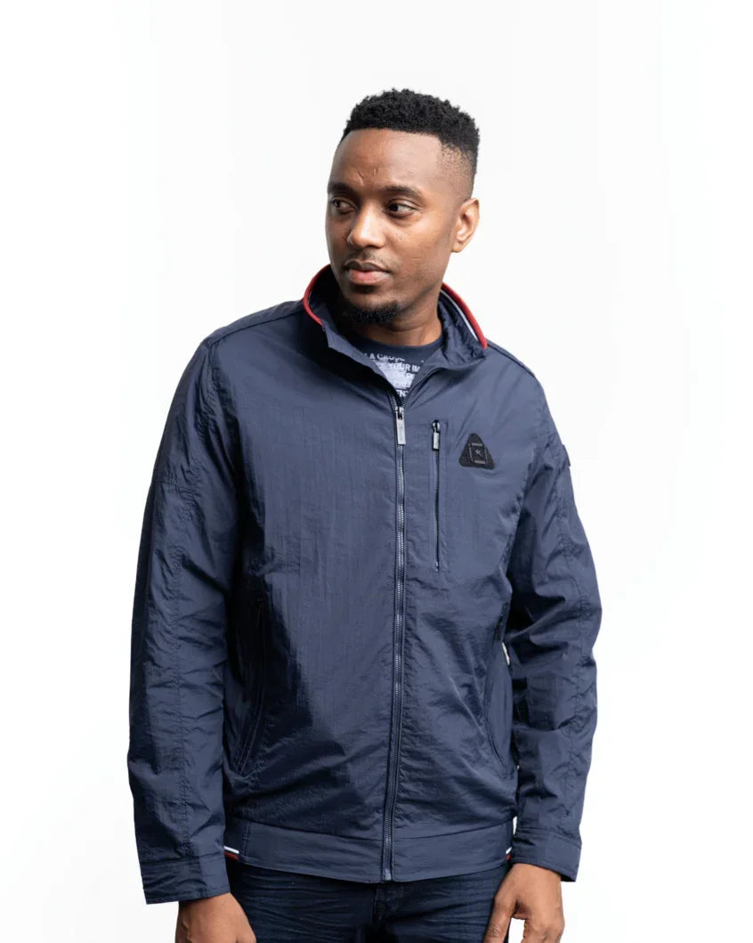 Men's lightweight jacket in navy; zip-up front, stand collar, small chest logo patch.