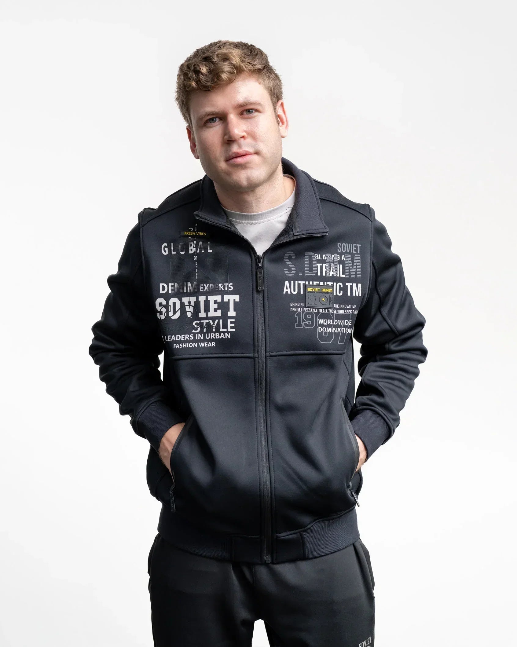 Black zip-up print jacket with full-zip front and chest graphics, standing