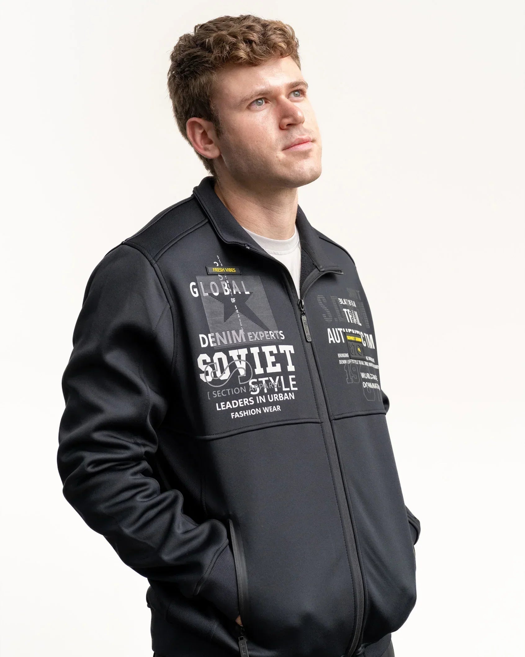 Black zip-up print jacket with chest graphic, side profile view