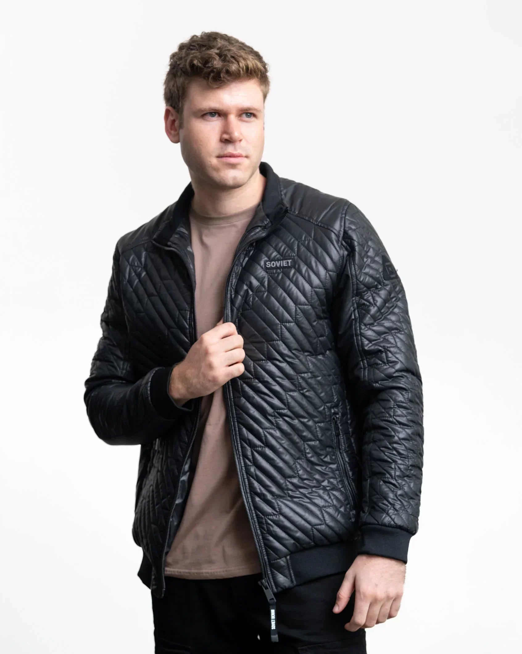 Black quilted jacket with stand collar, full-zip front, and ribbed cuffs and hem.