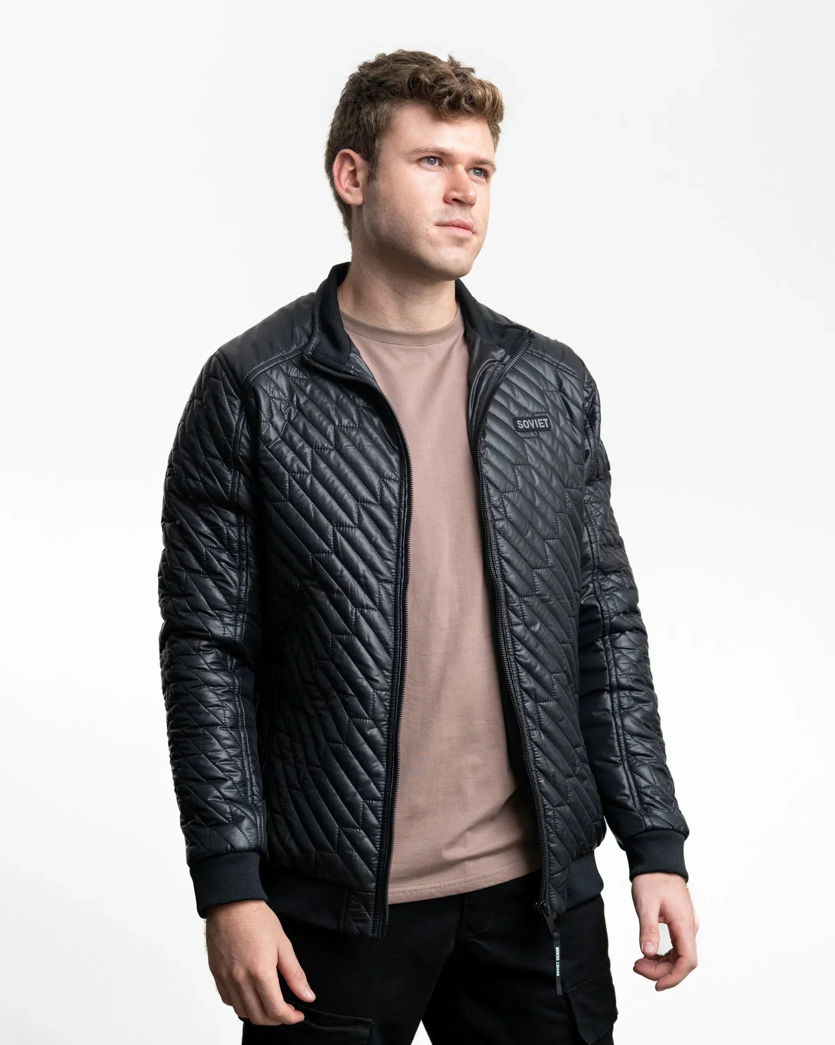 Black quilted jacket with zip front and stand collar, showing diamond quilting.