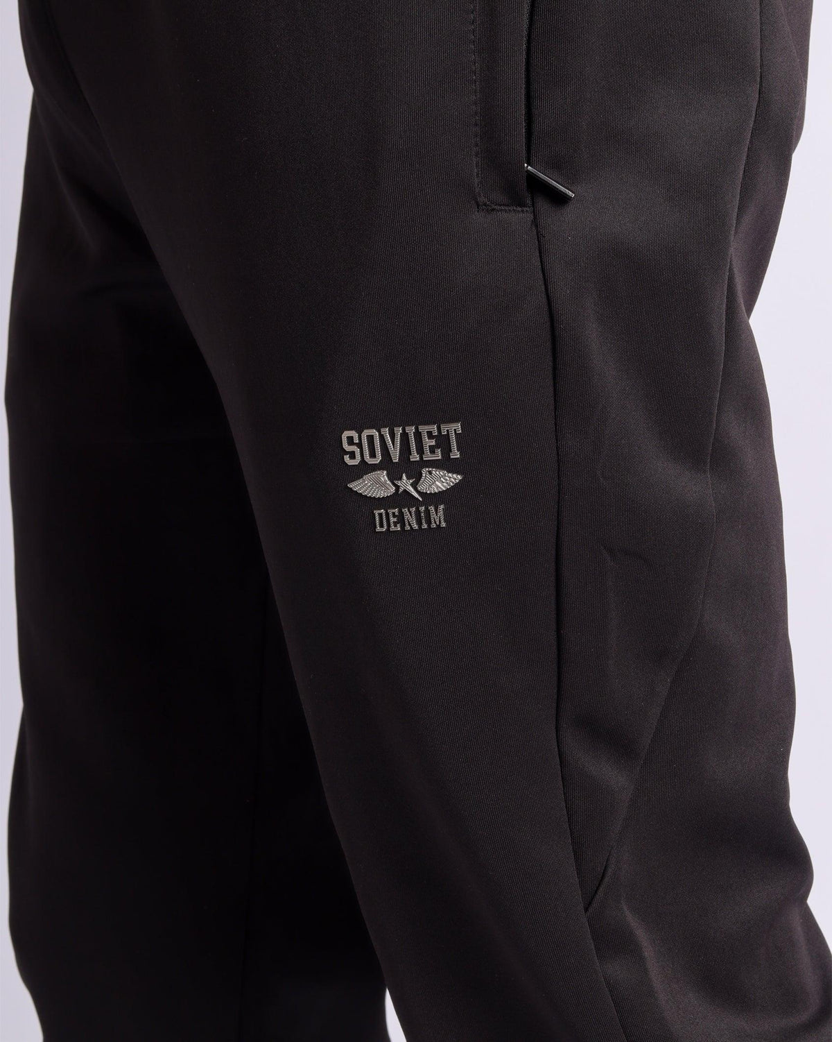 Soviet Mens Aero skinny leg pants in dark fabric, close-up view of stylish men's apparel with fitted silhouette.