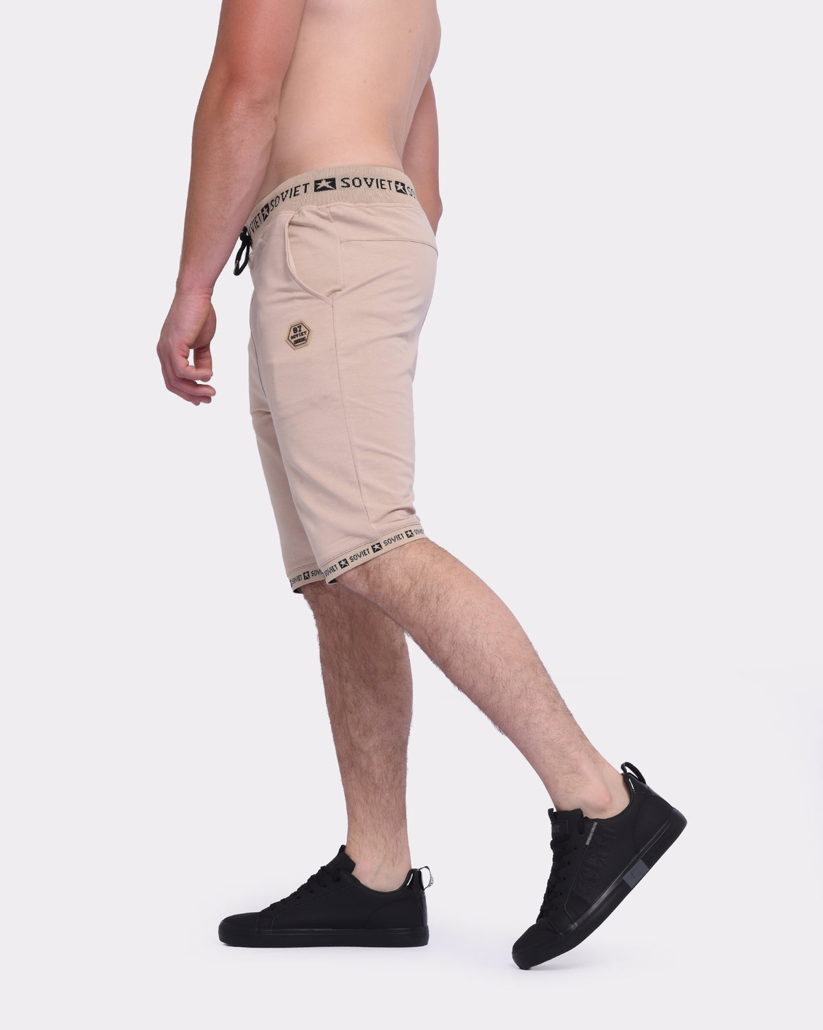 Men's Soviet Keeper track shorts in sand shell fabric, featuring a comfortable athletic design with elastic waistband.