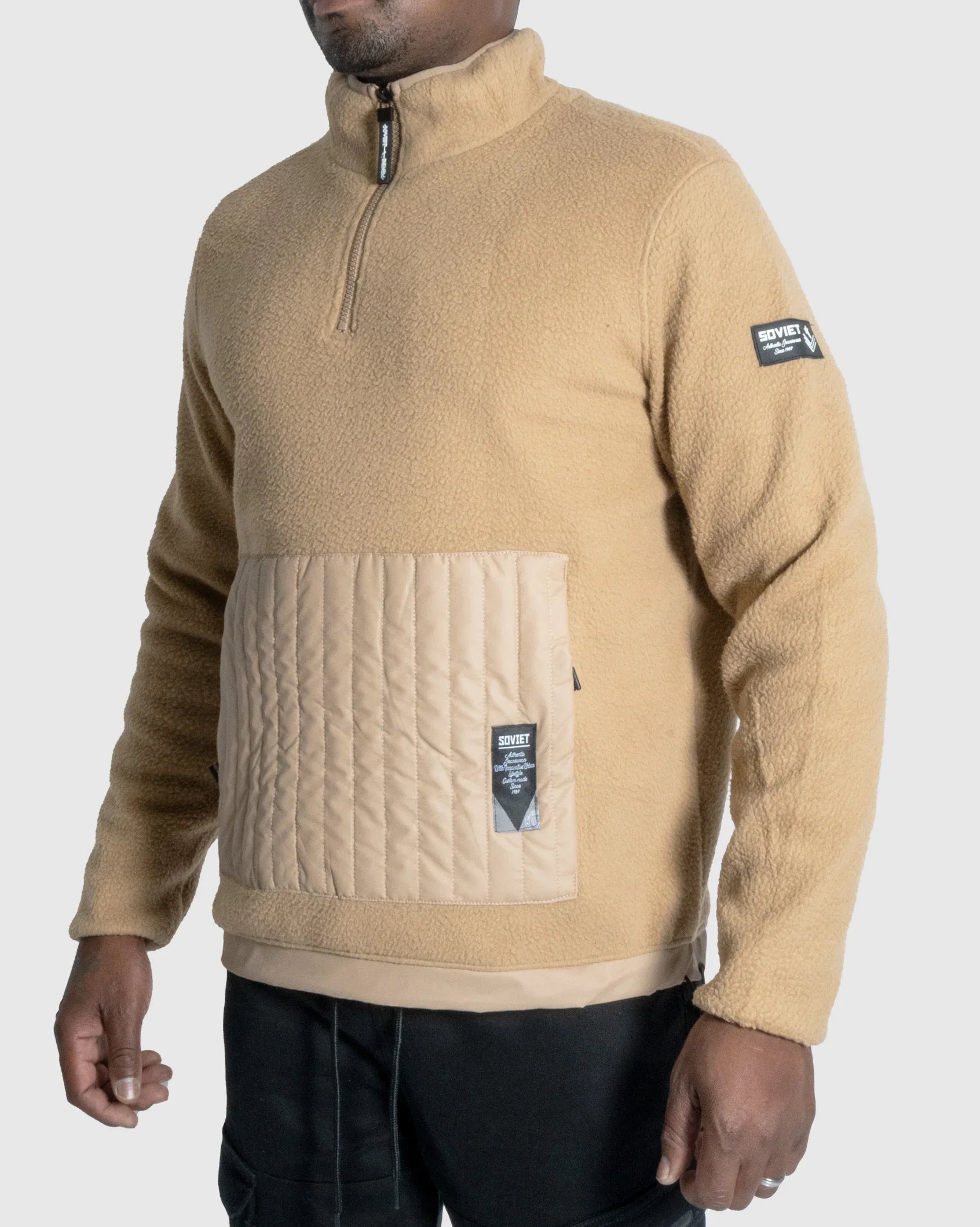 Camel fleece quarter-zip jacket with quilted front pocket panel and sleeve label patch