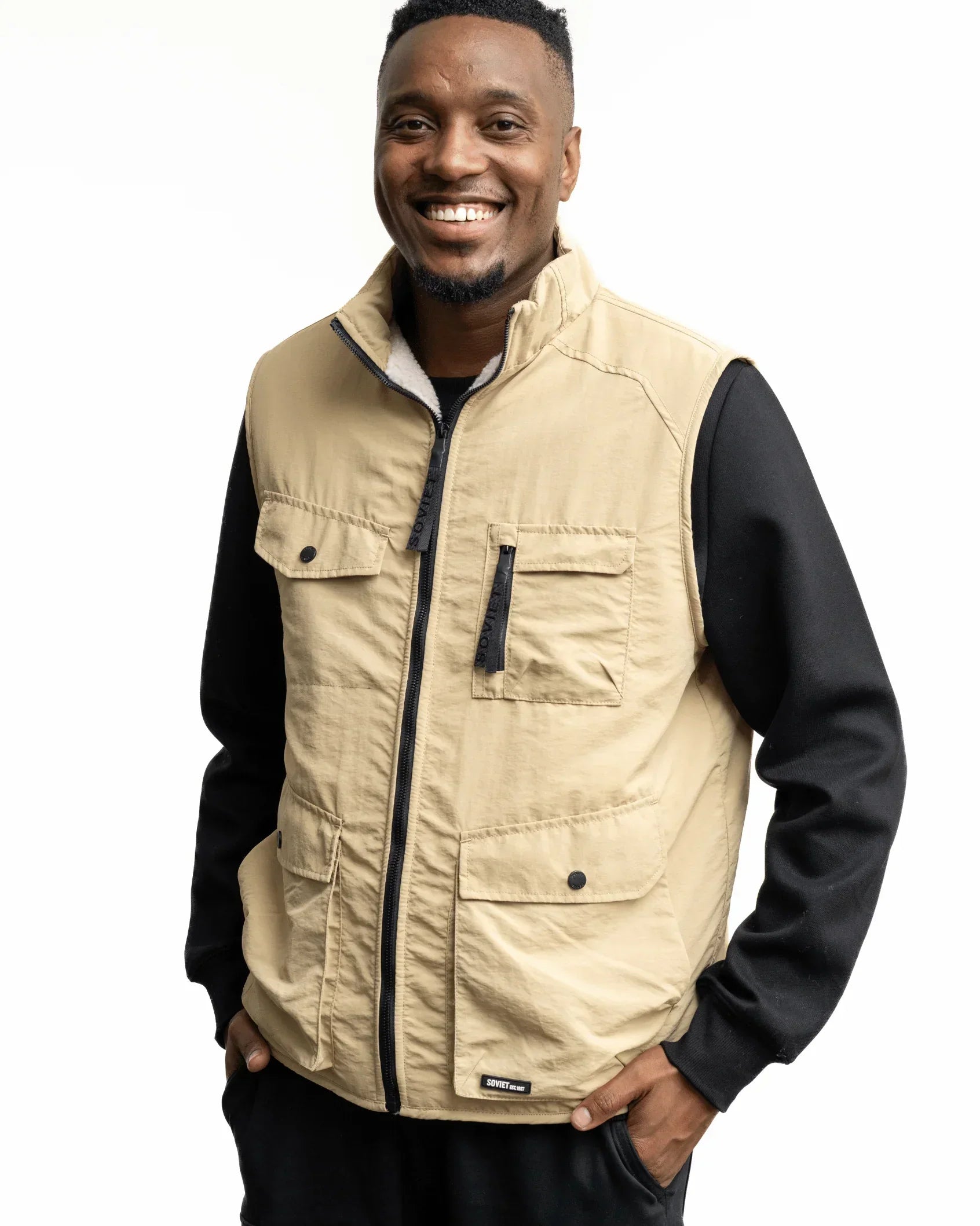 Men's stone fashion gilet front view with black zip and two flap chest pockets
