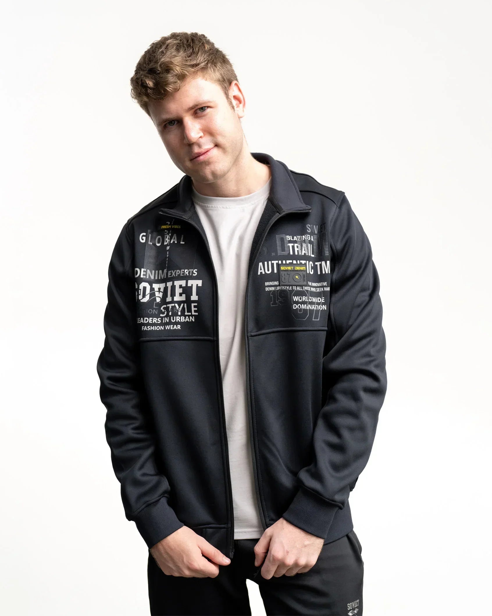Black zip-up print jacket with chest and sleeve graphics, front view