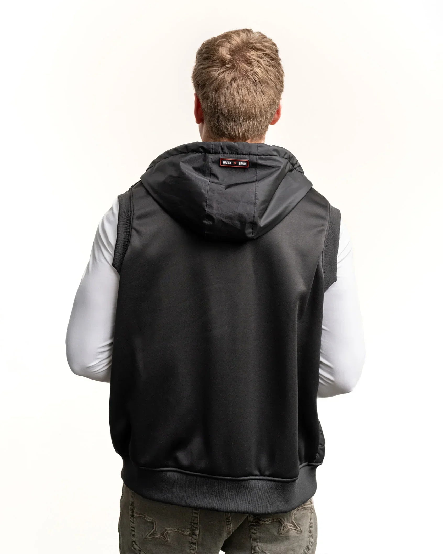 Black hooded padded gilet from back with hanging hood and small center label