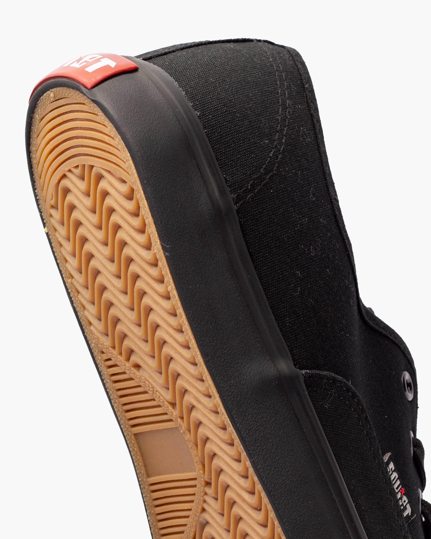 Black canvas low-top sneaker with gum rubber sole and lace-up front