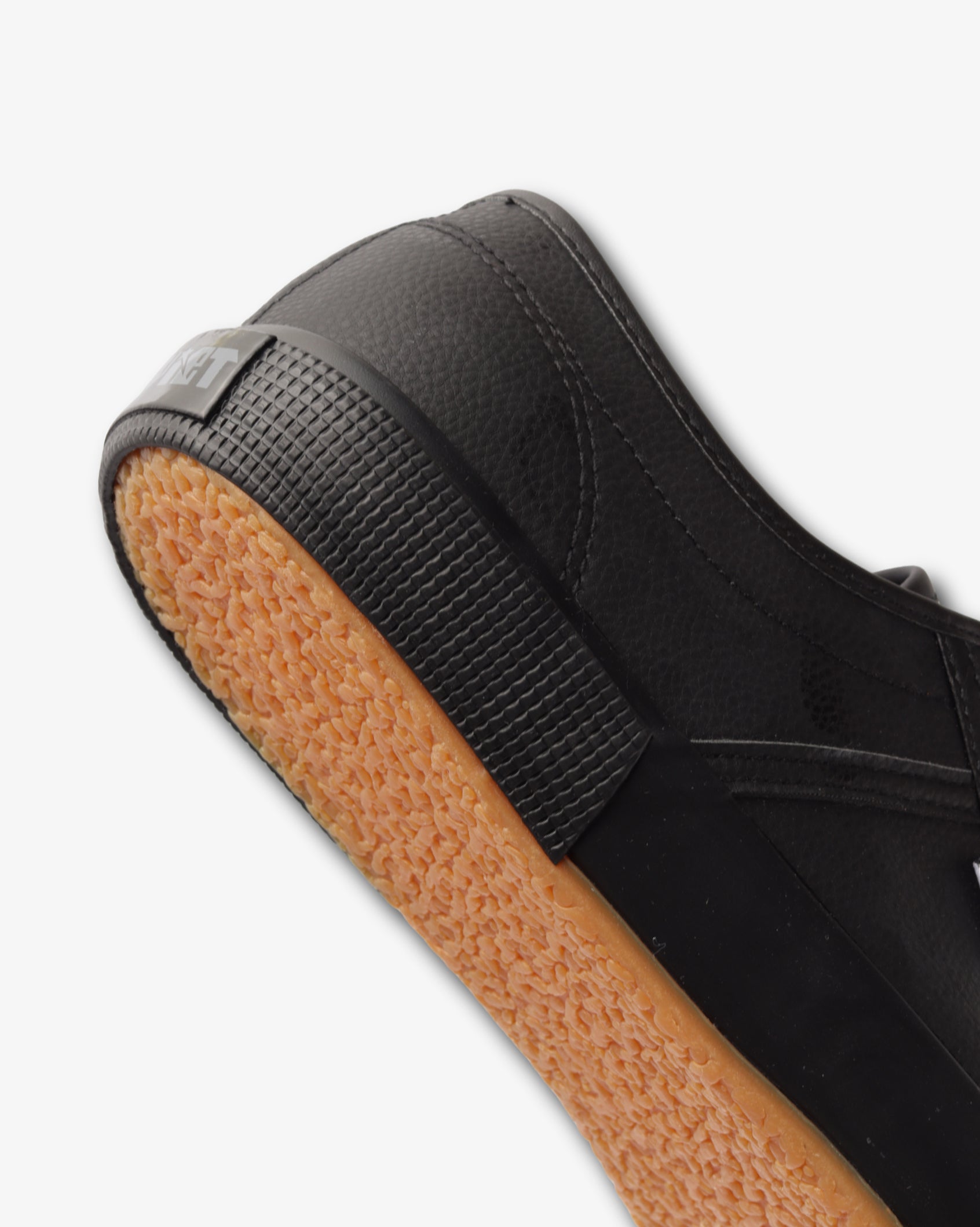 Men's low-cut PU sneaker, black upper; textured tread outsole detail