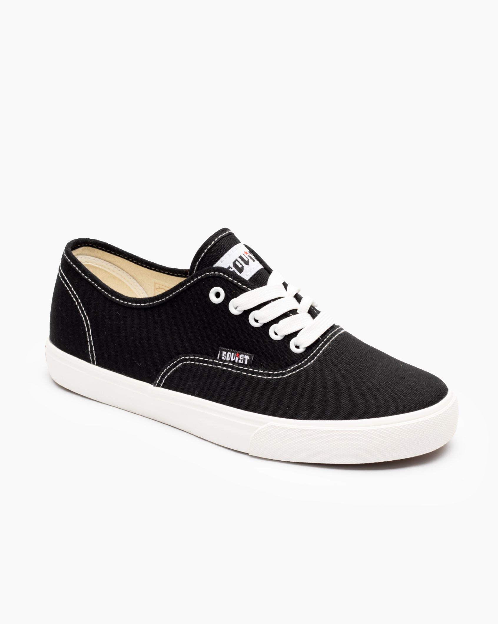 Men's low-cut canvas sneakers, black with white laces and white rubber sole.