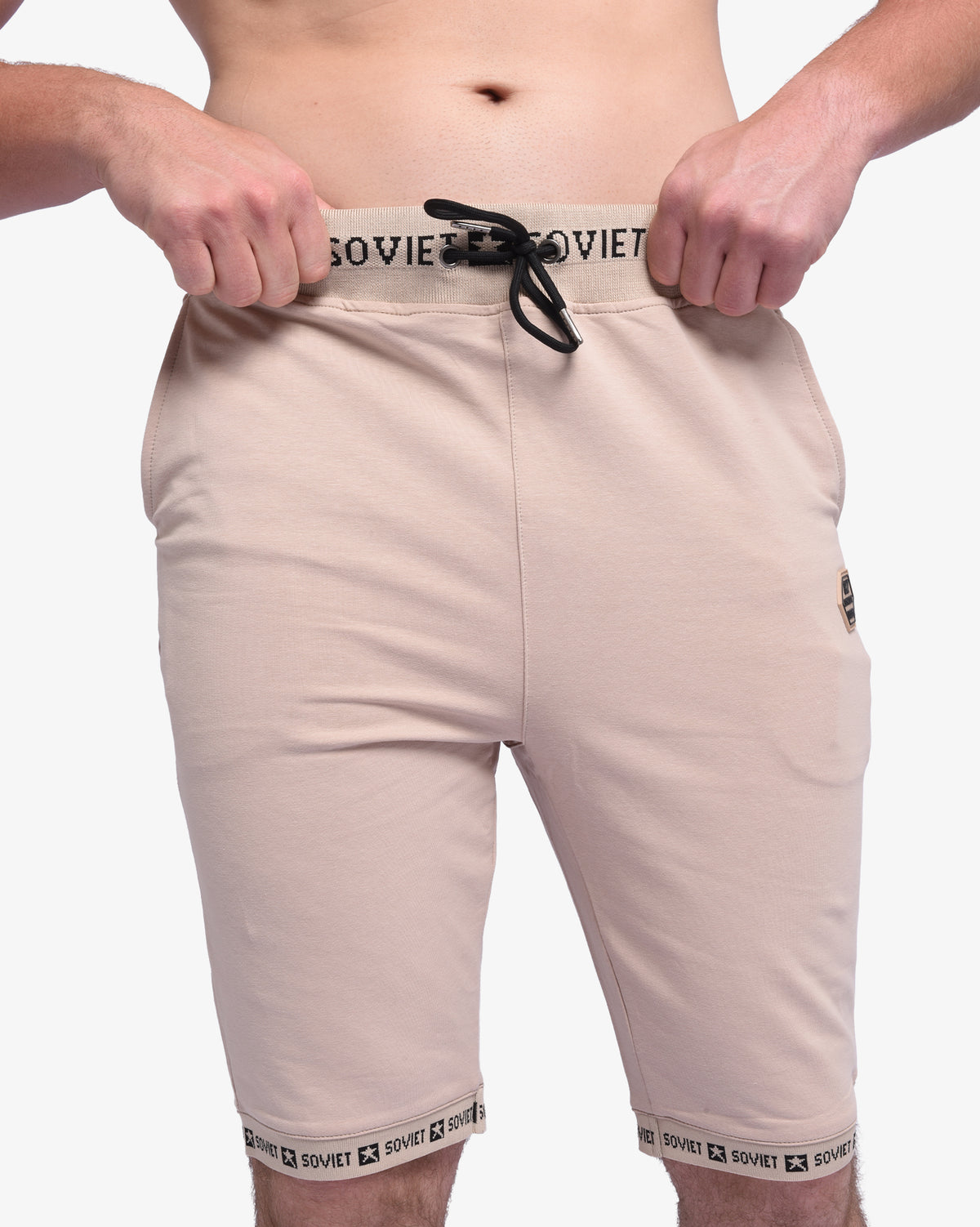 Men's Soviet Keeper track shorts in sand shell fabric, casual athletic apparel with adjustable waistband and side pockets.